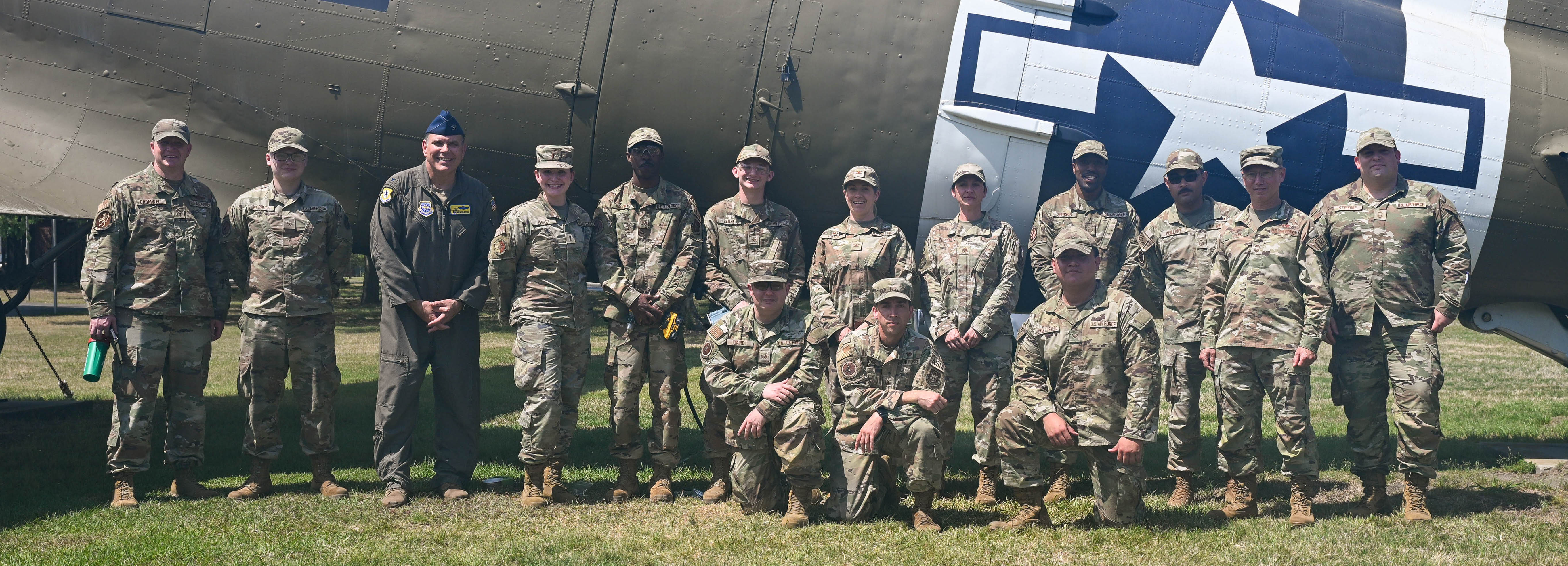 A photo of Airmen standing in front of a C-47 Skytrain.