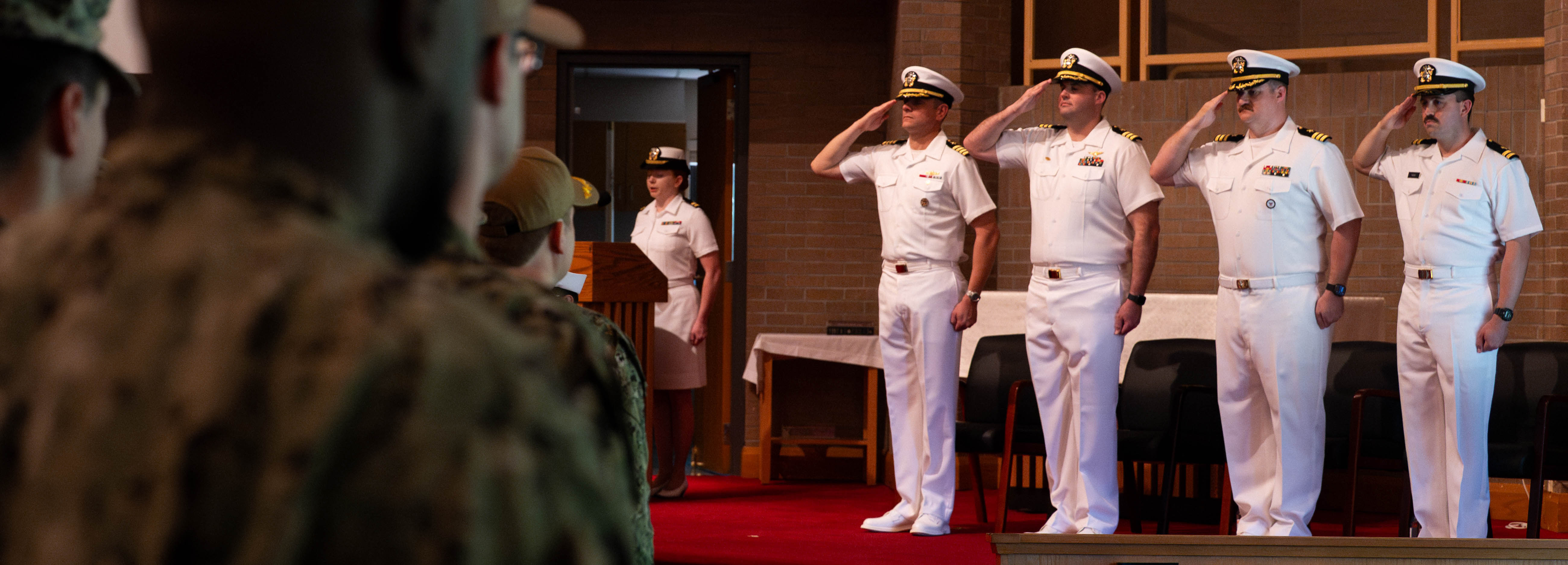 A photo of two men saluting each other.