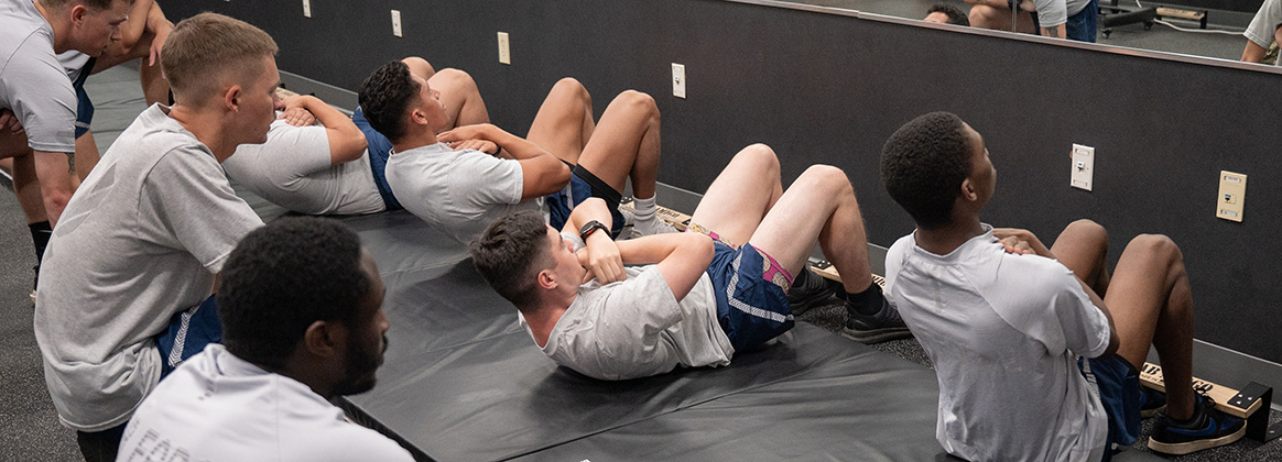 U.S. Airmen perform sit ups during the physical fitness readiness assessment. 