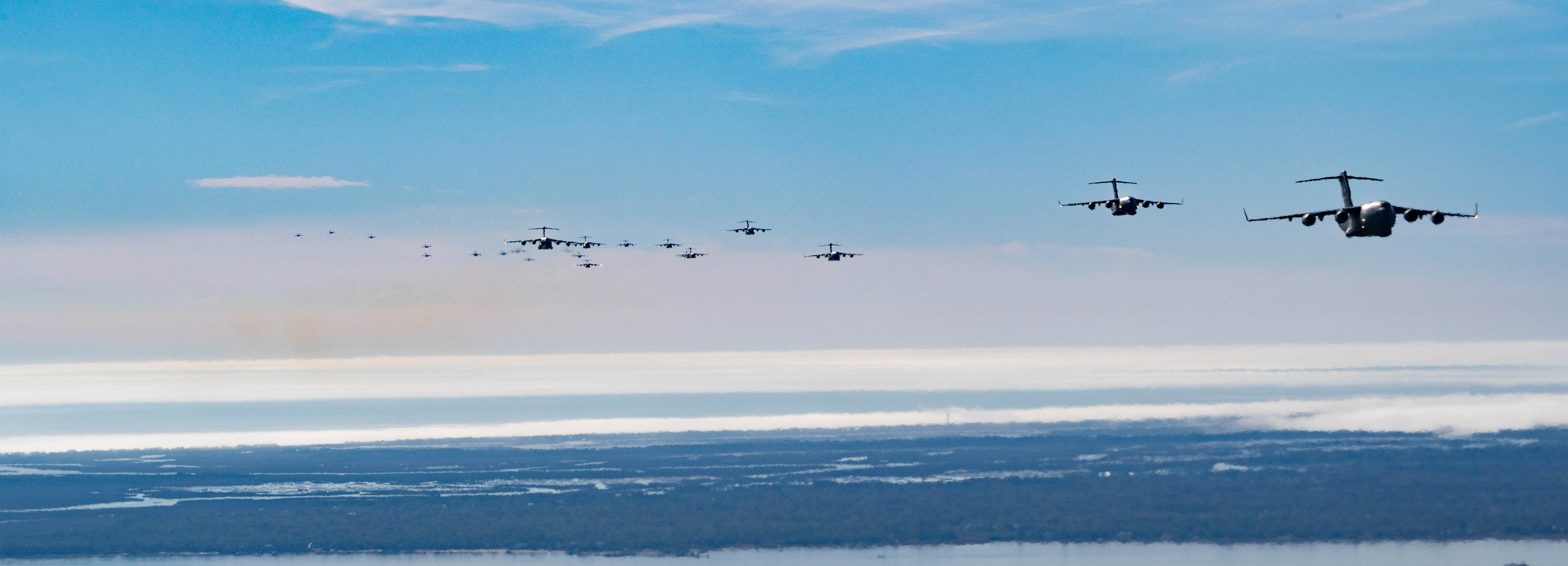 A formation of C-17 aircraft fade into the sky over the landscape of Charleston.